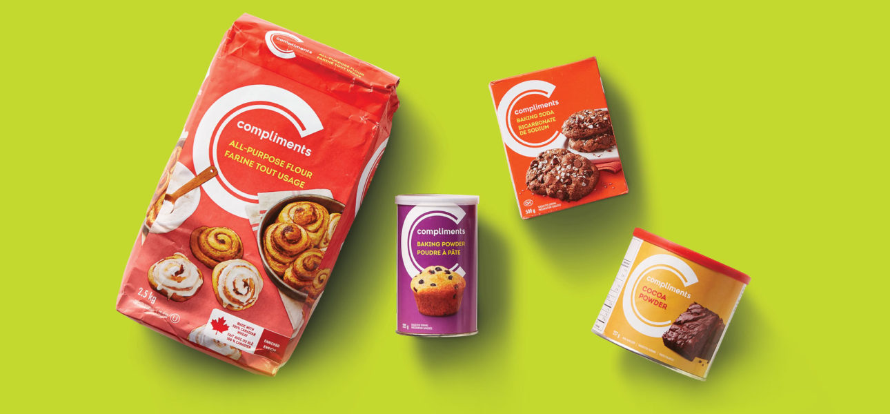 Four products are pictured together. From left to right: Compliments all-purpose flour, Compliments baking powder, Compliments Baking soda, and Compliments cocoa powder.